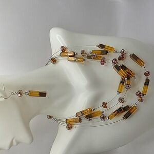 Contemporary multi strand beaded amethyst colored necklace and earrings set